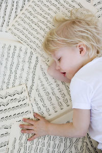 Girl sleeping on music sheets