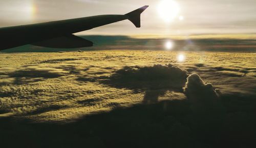 Cropped image of airplane flying over sea