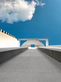 Bridge against cloudy sky in city