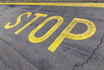 Yellow stop text on road