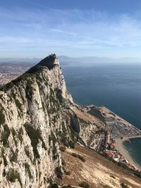 Scenic view of sea and mountains against sky