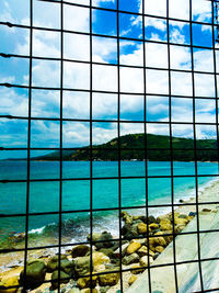 View of sea seen through glass window