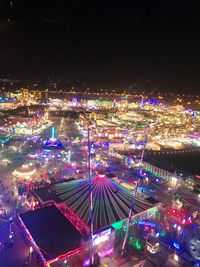 High angle view of illuminated cityscape against sky at night