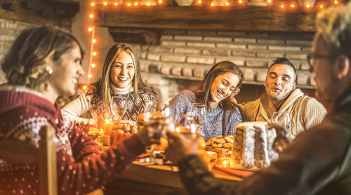 People enjoying drinks and food on table