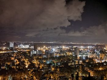 High angle view of illuminated buildings against sky at night