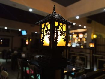 Illuminated pendant lights hanging in restaurant