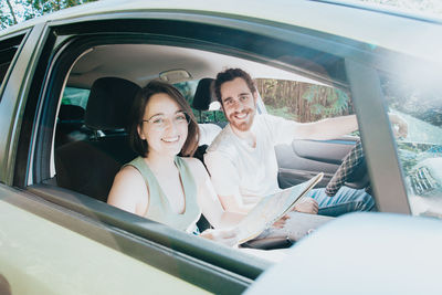 Portrait of smiling woman sitting in car