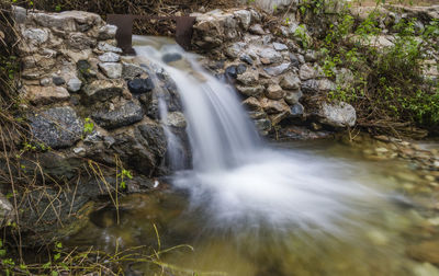 Scenic view of waterfall in forest