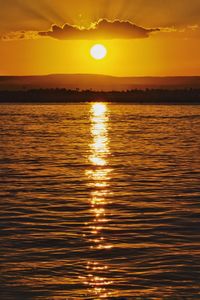 Scenic view of sea against orange sky