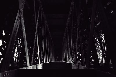 Low angle view of illuminated bridge at night