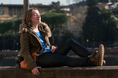 Young woman relaxing outside in spring sunny day. mental health concept. italy, florence