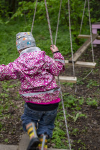 Rear view of girl playing at playground