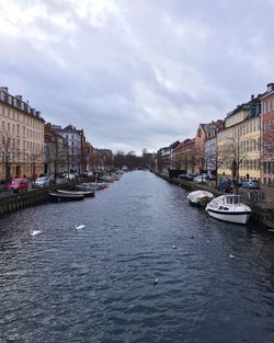 Boats in canal with buildings in background