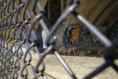 Chainlink fence against metallic wall