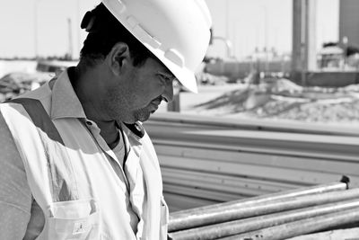 Architect looking away while standing at construction site