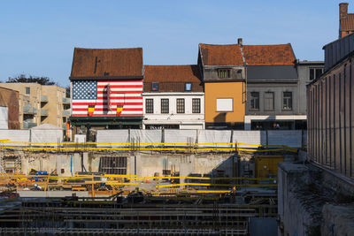 Buildings in city against clear sky