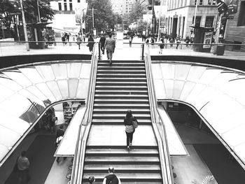 People on staircase in city