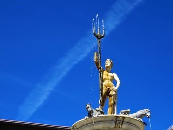 Low angle view of statue against blue sky