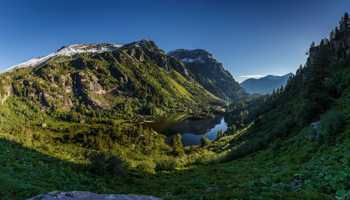 Scenic view of mountains against clear blue sky