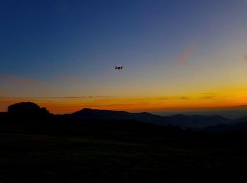 Scenic view of silhouette landscape against sky during sunset