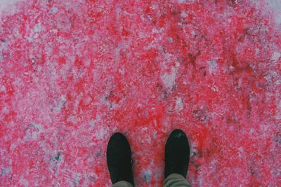 Low section of person standing on tiled floor