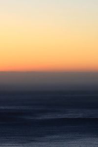 Scenic view of sea against romantic sky at sunset