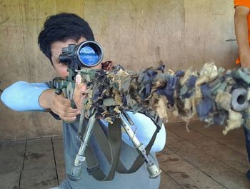 Close-up of a sniper aiming rifle