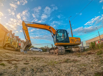 Construction site by road against sky