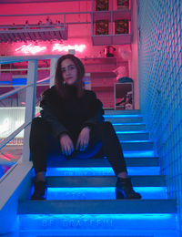 Portrait of woman sitting on staircase