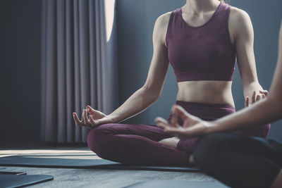 Midsection of woman sitting at home