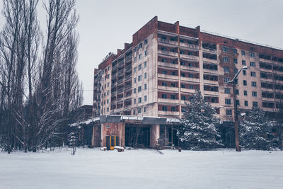 Snow covered buildings against sky