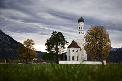 Built structure on field against sky