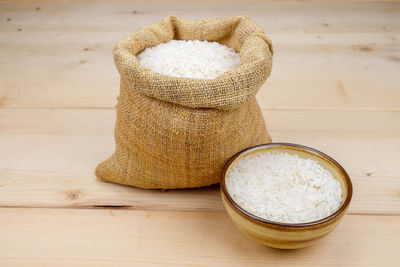 Close-up of rice in bowl on wood
