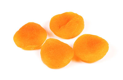 Close-up of orange fruit against white background