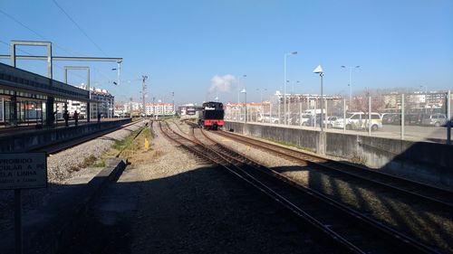Train at railroad station against clear sky