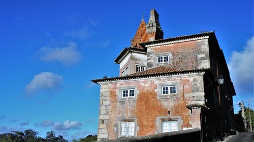 Low angle view of old building against blue sky