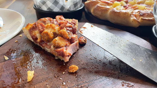 High angle view of pizza on cutting board