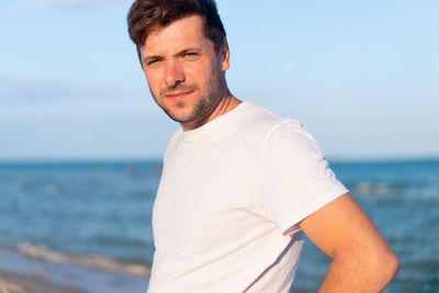 Man standing by sea against sky