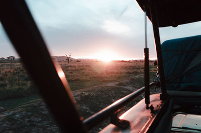 Scenic view of sunset seen through car window