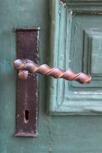 Close-up of hand on metal door
