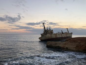 Ship on sea against sky during sunset