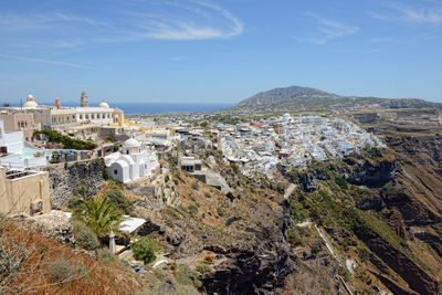 High angle view of town by sea against sky