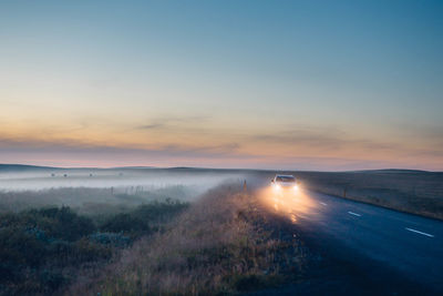 Scenic view of car driving through countryside