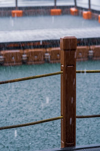 Wooden pole with mooring rope under the heavy rain. tourism, monsoon and tropical country.