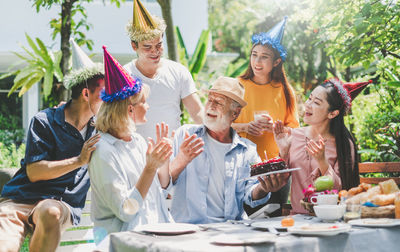 Rear view of people sitting on table