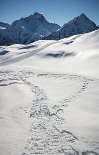 Scenic view of snowcapped mountains against sky