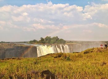 Scenic view of waterfall against sky