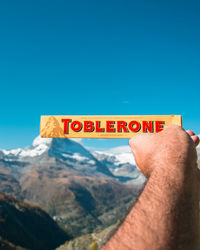 Low section of man against sky