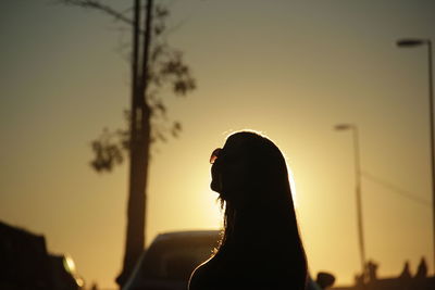 Side view of silhouette woman against clear sky