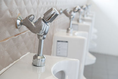 Close-up of faucet in bathroom